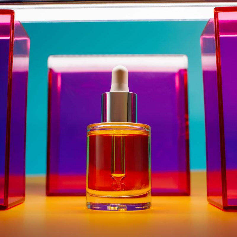 face-oil-in-glass-bottle-on-yellow-and-blue-backgr-2024-05-07-00-47-03-utc.jpg